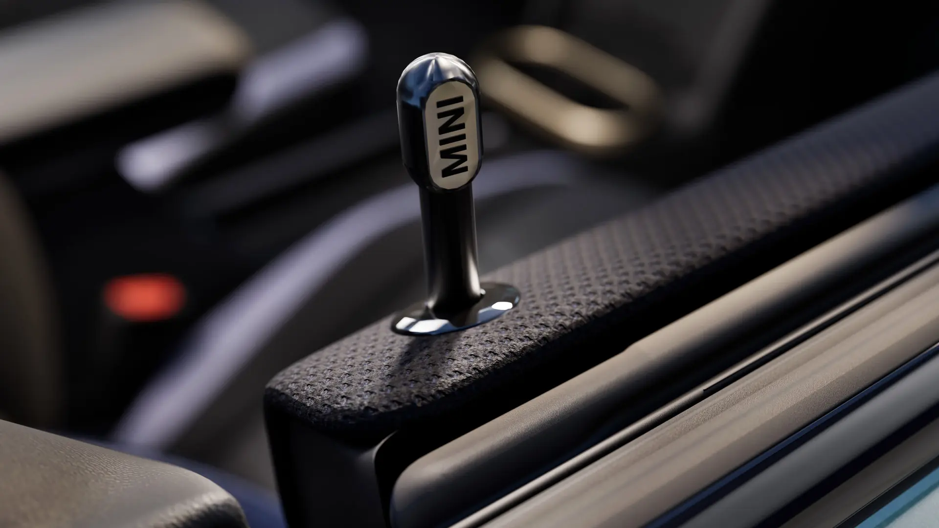 Gros plan de la goupille de verrouillage de porte intérieur MINI authentique en aluminium anodisé noir.