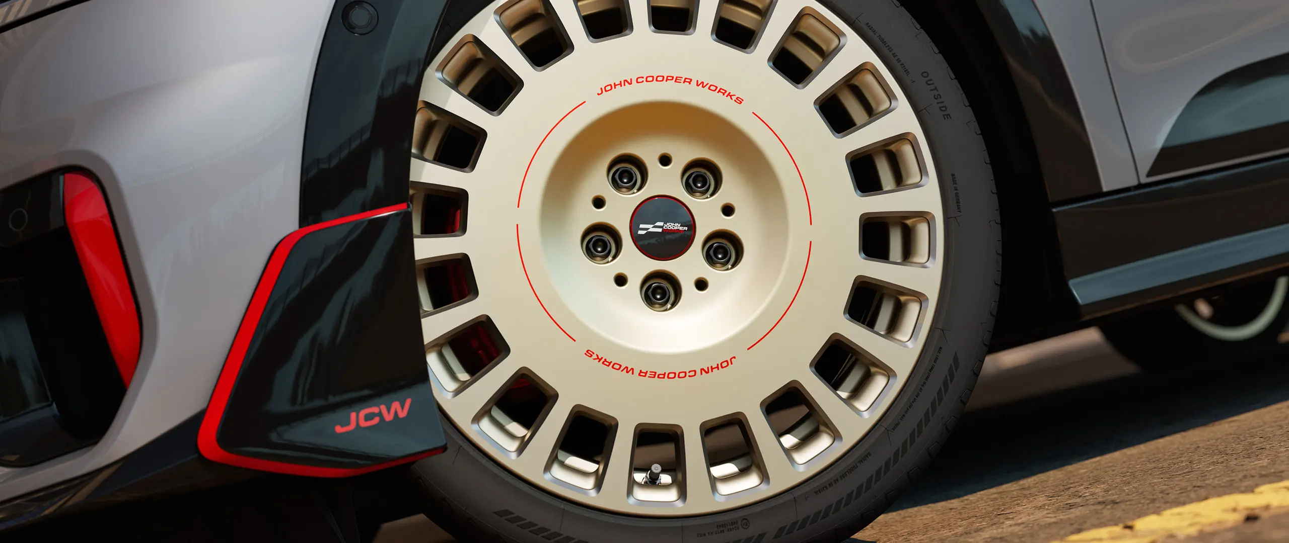 Gros plan d'une jante JCW 18" Rallye Spoke 964 en Vibrant Silver bicolore, diamantée avec ailette avant.