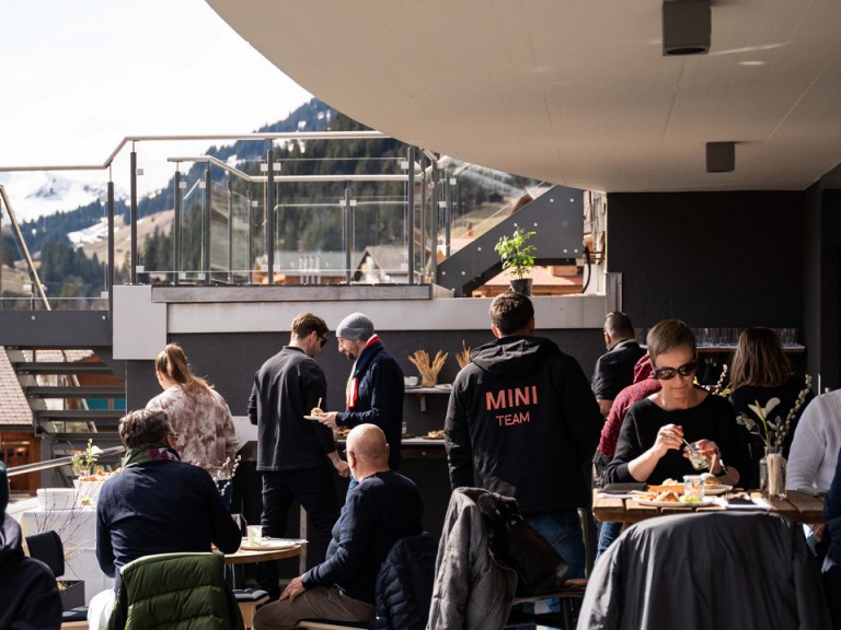 Guests on terrace in mountain setting