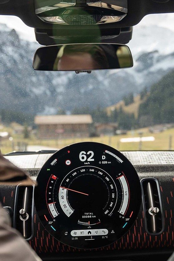 MINI cockpit interior shot passengers looking out at mountains MINI cockpit interior shot passengers looking out at mountains