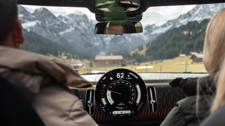 MINI cockpit interior shot passengers looking out at mountains MINI cockpit interior shot passengers looking out at mountains